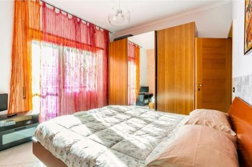 a bedroom with a large bed with red curtains at Camera Prestige in Rome