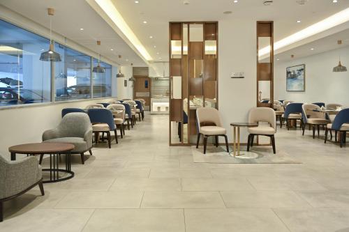 a waiting area in a hospital with chairs and tables at Comfort Hotel Jeddah King Road in Jeddah