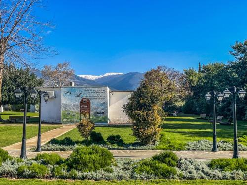 a park with a sign and mountains in the background at Erettz Dafna Travel Hotel in Metsudat Menahem Ussishkin Alef