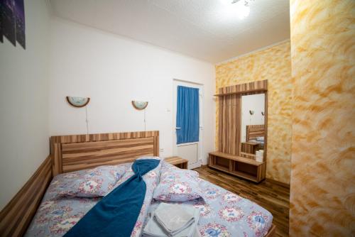 a bedroom with a bed and a mirror at Casa Cosmina Arieseni in Arieşeni