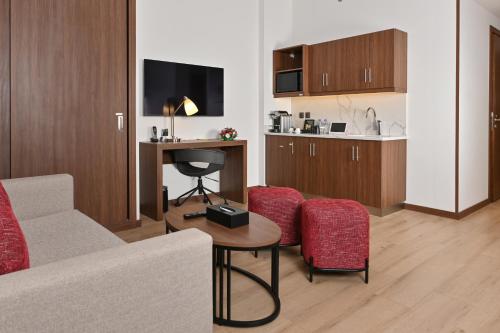 a living room with a couch and a table and chairs at Comfort Hotel Jeddah King Road in Jeddah