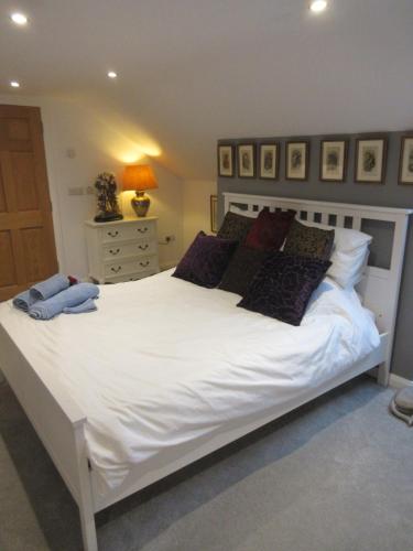 a bedroom with a large white bed with pillows at Straleel South in Carrick