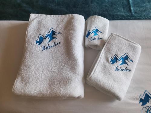two towels with mountains on them on a bed at BELVEDERE A9 ( N LUX MILMARI RESORT) in Kopaonik