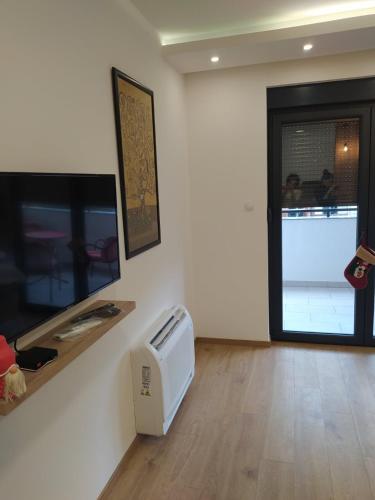 a living room with a tv and a window at LanaMarija Apartment in Trebinje