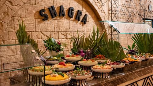 a buffet of food on display in a building at Marsa Shagra Village in Abu Dabab