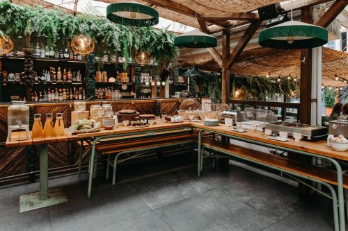a restaurant with a bar with lots of alcohol at Hôtel PALMITO in Biarritz