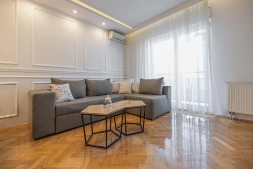 a living room with a couch and a table at Apartment Marina in Novi Sad