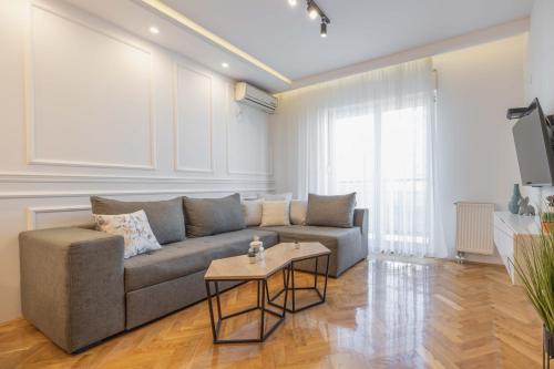 a living room with a couch and a table at Apartment Marina in Novi Sad