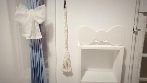 a white closet with a white curtain and a broom at Whitiedoggie Villa II in Checheng