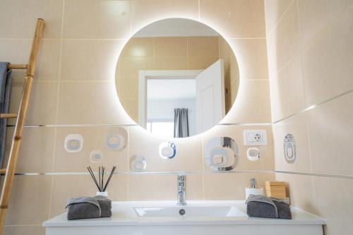 a bathroom with a sink and a mirror at Ocean Vibes with sea view and private heated pool in Callao Salvaje