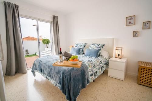 a bedroom with a bed with a tray of fruit on it at Ocean Vibes in Callao Salvaje