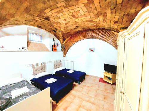 two beds in a room with a wooden ceiling at Trastevere in Music in Rome