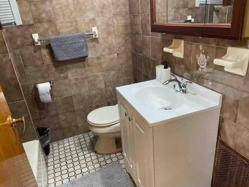 a bathroom with a white sink and a toilet at 20 Min to Manhattan New 3 Bed 1 Bath None smoked in Bronx