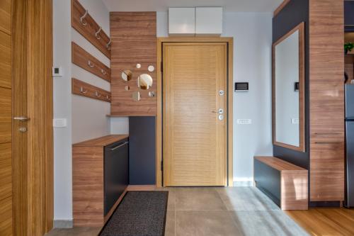 a hallway with a wooden door in a house at Apartman Thalia Kalman in Zlatibor