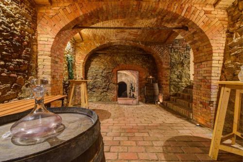a glass vase sitting on a table in a brick tunnel at Privat Bohemia in Šatov