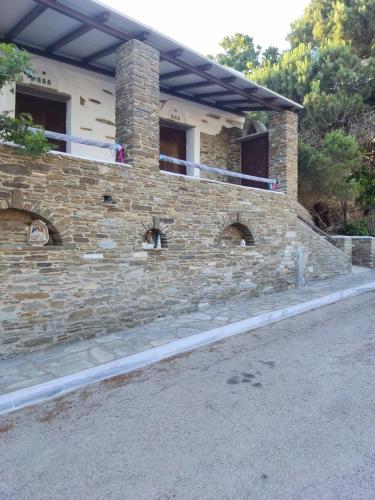 a brick house with a balcony on top of it at Monte Kechros in Arnados