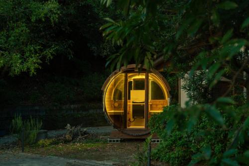 a small yellow train car sitting on the tracks at 木木木木 KIGI MOKU MOKU in Sasebo