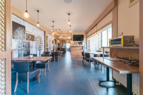 a dining room with wooden tables and chairs at Hotel Villa Sarto in Belgrade