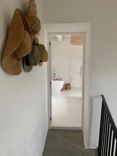 a hallway with a door to a bathroom with a sink at Magnifique Mas Cevenol in Anduze