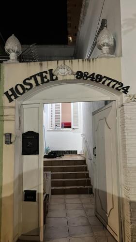 an entrance to a building with a door and stairs at Grande Família Hostel Av paulista in Sao Paulo