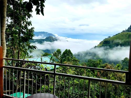 a view from a balcony of a mountain with clouds at Ella HIDE VIEW in Ella