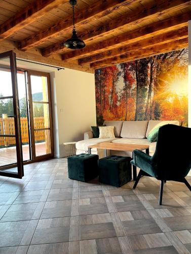 a living room with a couch and a table at Wierchy Beskidu in Dobra