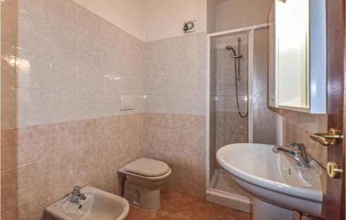 a bathroom with a sink and a toilet and a shower at 2 Bedroom Beautiful Apartment In Castelsardo in Castelsardo