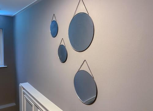 a wall with three mirrors hanging on a wall at Hotel de Slapende Hollander - Economy in Kaatsheuvel