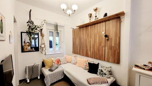 a living room with a couch and a wooden door at House Bairro Estrela D`Ouro in Lisbon