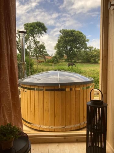 a hot tub in a window with a view of a field at gites de Warincthun in Audinghen