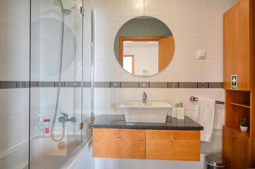 a bathroom with a sink and a shower at Levada dos Piornais, a Home in Madeira in Funchal