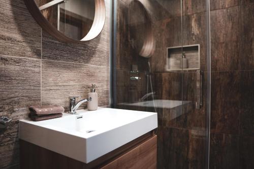 a bathroom with a white sink and a shower at Pension Pohoda in Malá Morávka