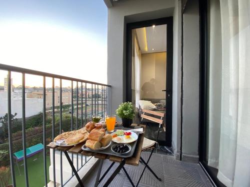 a tray of food on a table on a balcony at Appartement Cosy et chaleureux - Casablanca centre in Casablanca