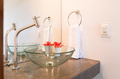 a bathroom sink with a glass bowl on a counter at Pousada Enseada Dos Golfinhos in Pipa