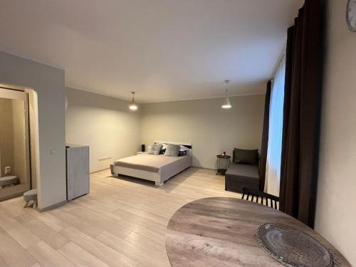 a bedroom with a bed and a chair in a room at Beautiful Apartment Great Location FREE PARKING in Rīga