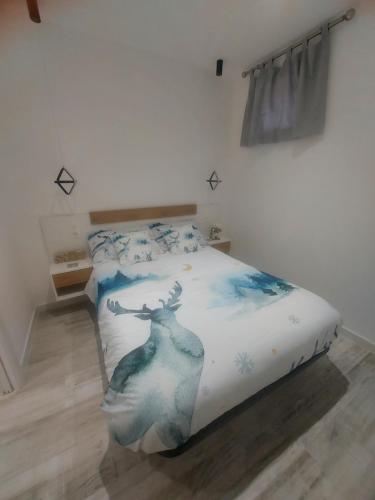 a bedroom with a bed with a picture of a deer on it at Apartamento Vista Nevada in Sierra Nevada