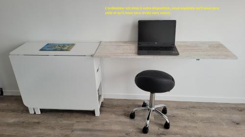 a desk with a laptop computer on top of it at Update Location in Lanester