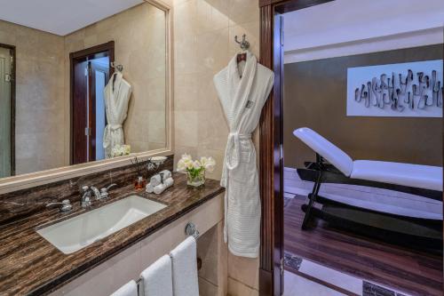 a bathroom with a sink and a mirror at Makkah Clock Royal Tower, A Fairmont Hotel in Makkah
