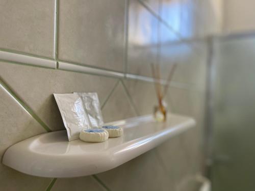 a bathroom sink with two toothbrushes on it at Mura Guest Room in Terralba