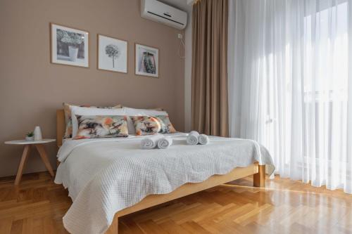 a bedroom with a bed with towels on it at Apartment Simpatico in Novi Sad