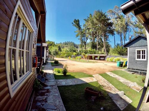 a side view of a house with a yard at CABAÑAS AIRES DE MAROMILLAS in Constitución