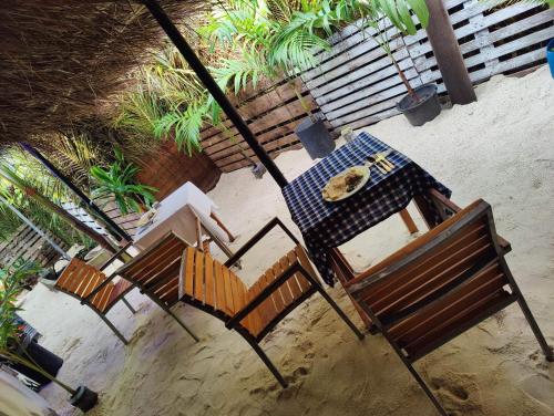 d'une table, de deux chaises et d'une table avec une plaque de cuisson. dans l'établissement Rashuthere Maldives, à Rasdhoo