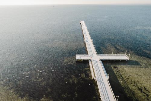 an aerial view of a bridge in the water at Villa Aqua BlueApart Jurata in Jurata