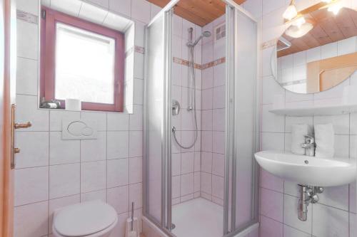 a bathroom with a shower and a toilet and a sink at Skirast - Kirchberg in Kirchberg in Tirol