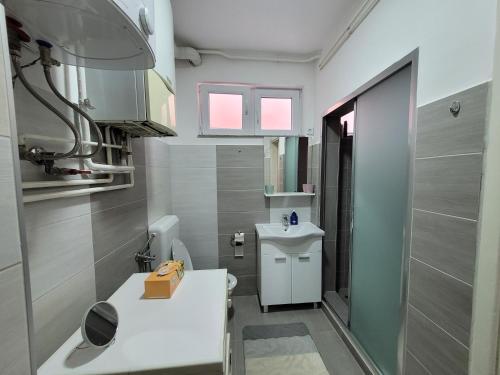 a bathroom with a white sink and a toilet at REMSA in Sarajevo
