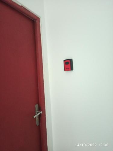 a door with a lock on it next to a red door at Porte Rouge in Capendu
