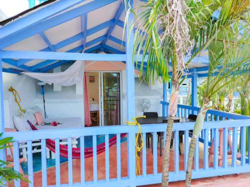 a room with a bed and a table and palm trees at B&B Aparthotel La Isleta in Las Galeras