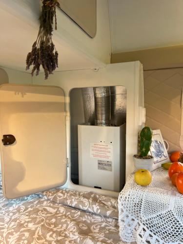 ajar door of a trailer with vegetables on a bed at Rent a BlueClassics 's campervan vw T3 in Algarve au Portugal, in Portimão