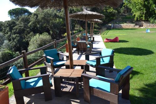 a row of tables and chairs with umbrellas at Herdade Do Freixial - Turismo Rural in Vila Nova de Milfontes