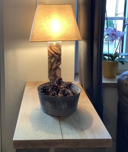 a lamp sitting on a table next to a table sidx sidx sidx at La Maisonnette in Porcheresse